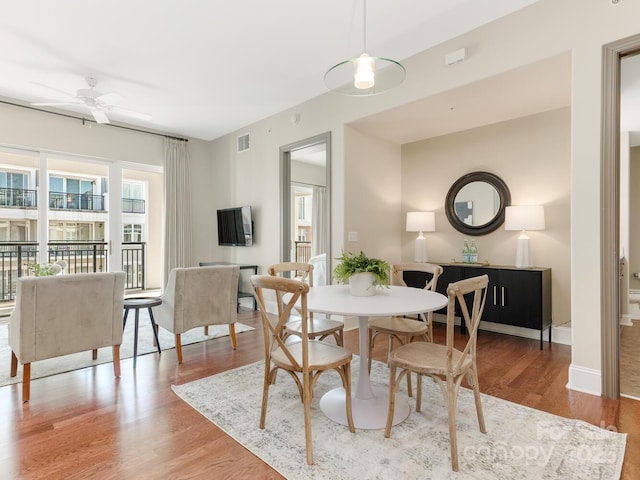 dining room with wood-type flooring and ceiling fan