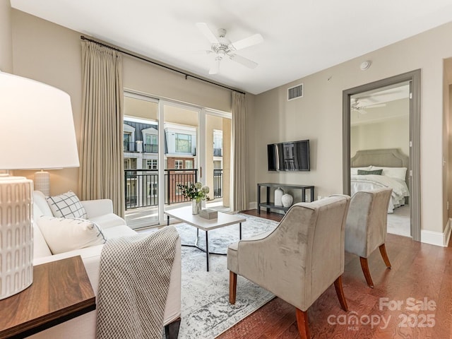 living room with ceiling fan and dark hardwood / wood-style floors