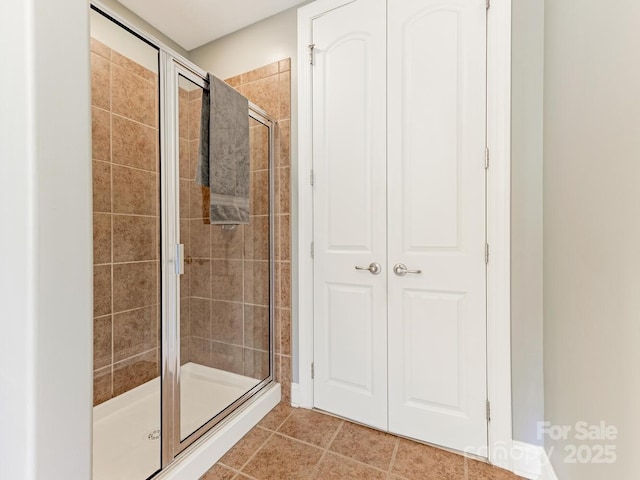 bathroom featuring walk in shower and tile patterned floors