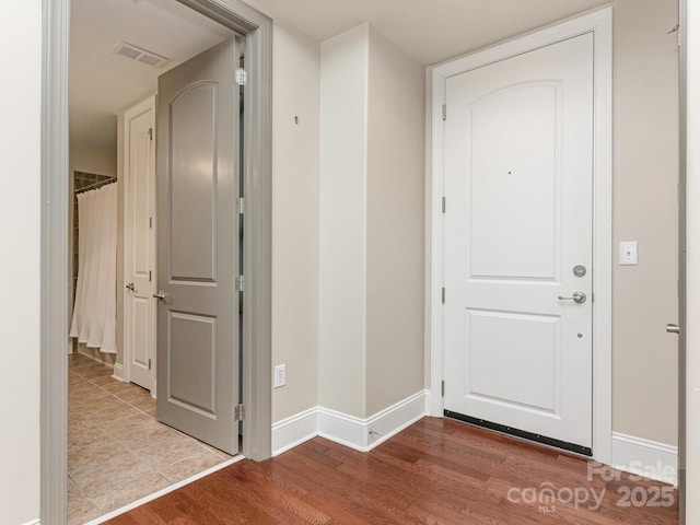 entryway with hardwood / wood-style flooring