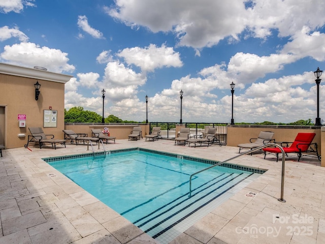 view of swimming pool with a patio