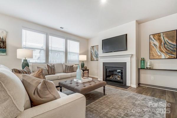 living room with a healthy amount of sunlight and dark wood-type flooring