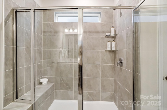 bathroom featuring a shower with door