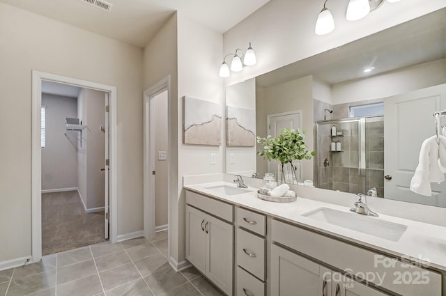 bathroom featuring an enclosed shower, vanity, and tile patterned flooring