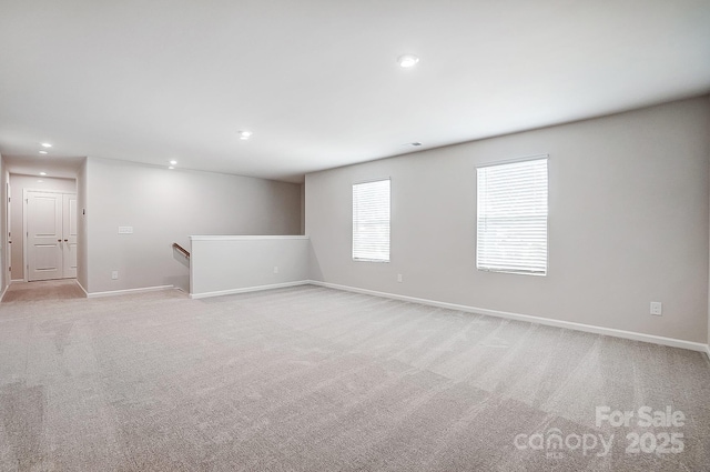 unfurnished room with light colored carpet