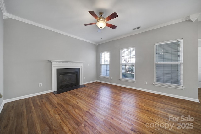 unfurnished living room featuring a fireplace with flush hearth, crown molding, baseboards, and wood finished floors