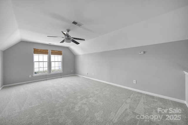 additional living space featuring ceiling fan, lofted ceiling, and carpet flooring