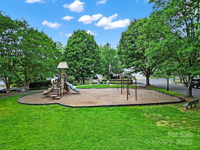 community jungle gym featuring a lawn