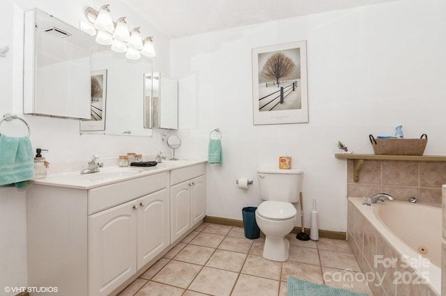 bathroom featuring toilet, tile patterned floors, tiled bath, and vanity