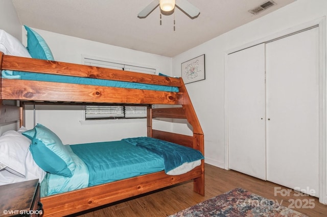 bedroom featuring ceiling fan, hardwood / wood-style floors, and a closet