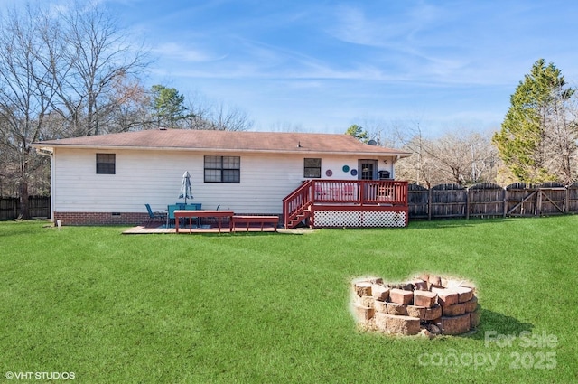 rear view of house featuring an outdoor fire pit, a yard, and a deck