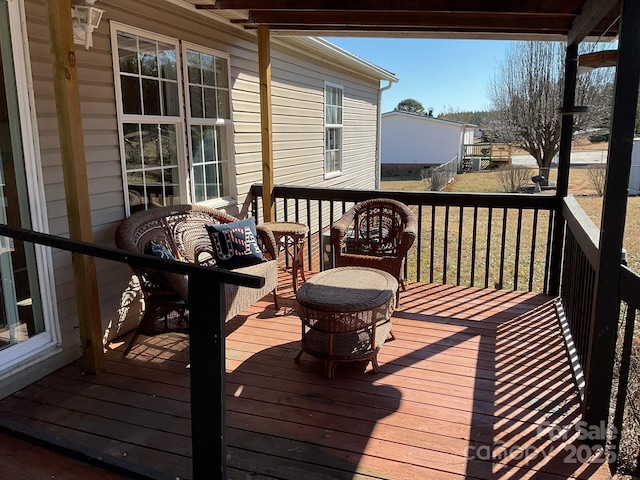 wooden terrace featuring a lawn