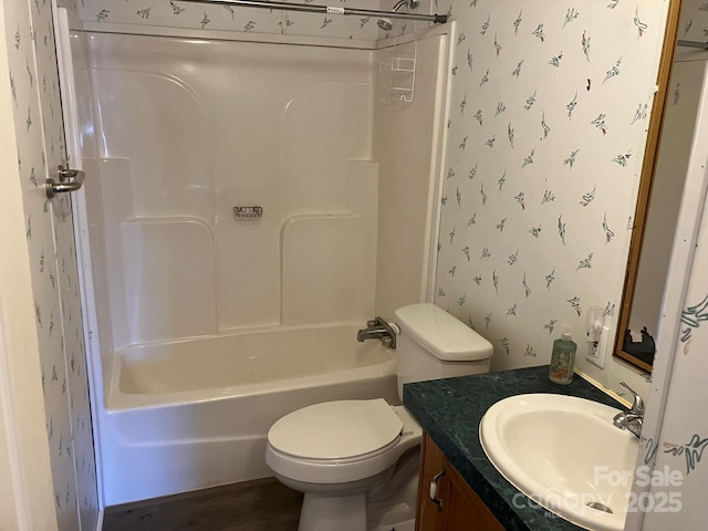 full bathroom featuring vanity, toilet, shower / washtub combination, and hardwood / wood-style floors