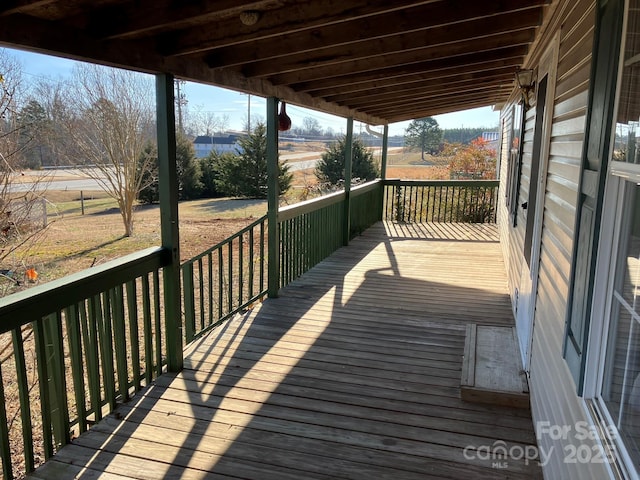 wooden terrace featuring a rural view