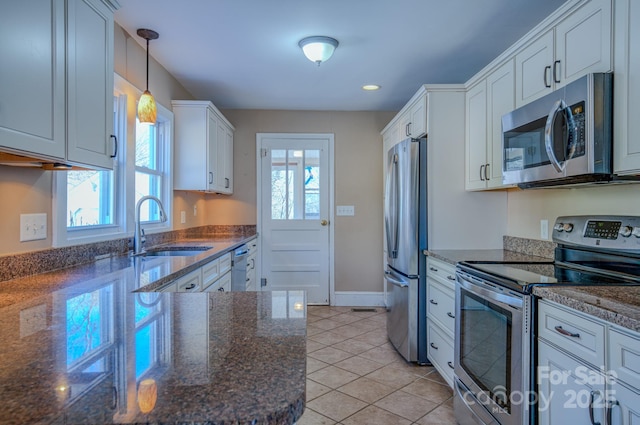 kitchen featuring pendant lighting, white cabinetry, appliances with stainless steel finishes, and a wealth of natural light