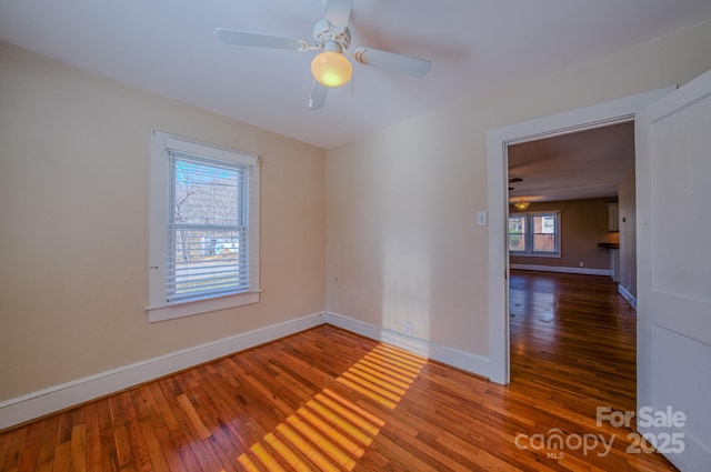 empty room featuring ceiling fan and dark wood-type flooring