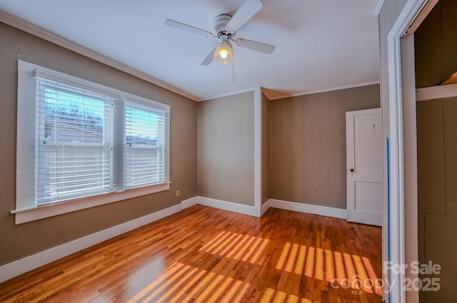 unfurnished room featuring ceiling fan, ornamental molding, and hardwood / wood-style flooring