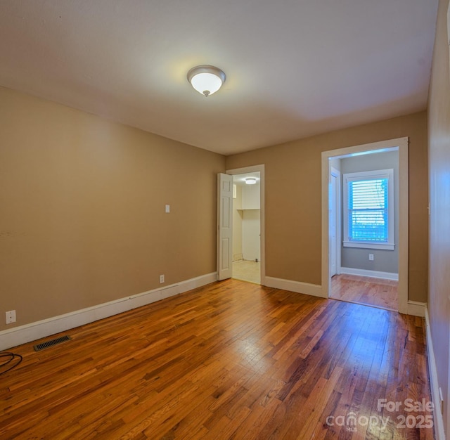 empty room with hardwood / wood-style floors