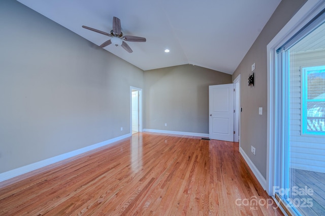 empty room featuring ceiling fan, vaulted ceiling, and light hardwood / wood-style flooring