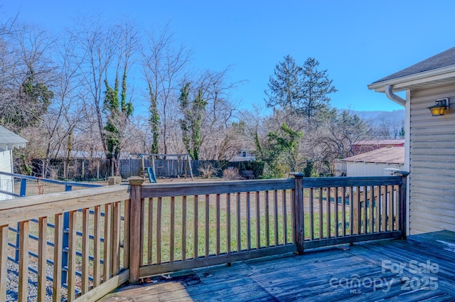 wooden deck featuring a yard