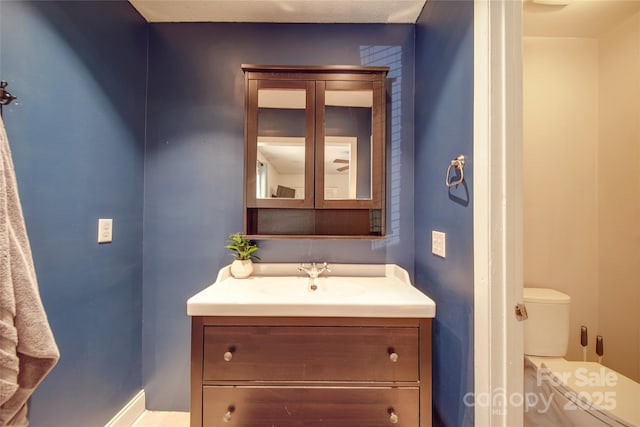 bathroom with toilet and vanity