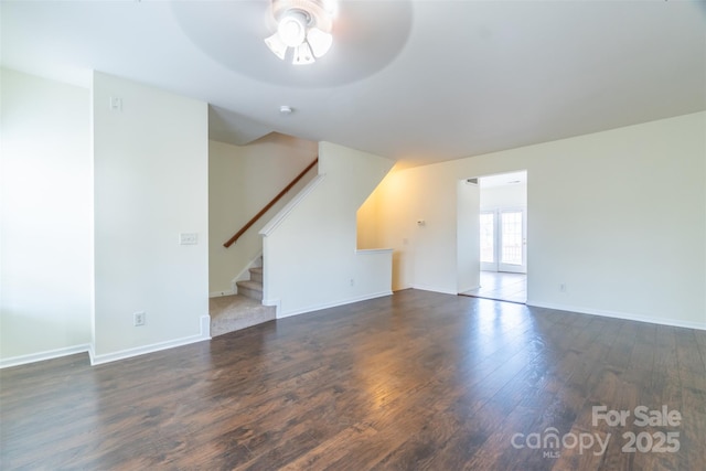 unfurnished living room with ceiling fan and dark hardwood / wood-style flooring