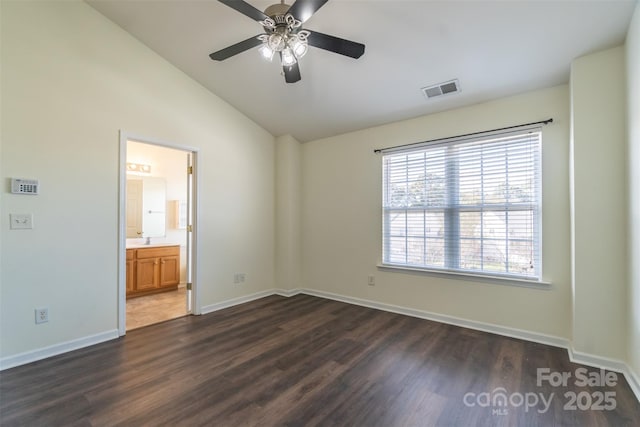 spare room with ceiling fan, lofted ceiling, and dark hardwood / wood-style floors