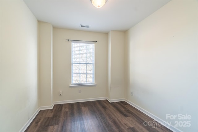 spare room featuring dark wood-type flooring