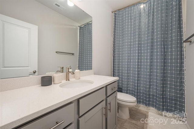 bathroom featuring vanity, tile patterned flooring, a shower with curtain, and toilet