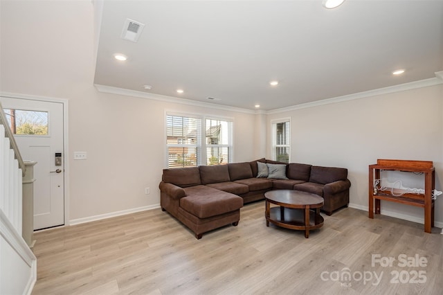 living room with ornamental molding and light hardwood / wood-style floors