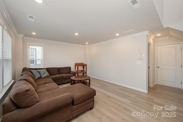 living room with ornamental molding and light wood-type flooring