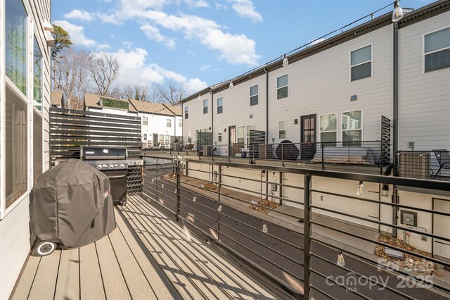 wooden deck featuring a grill