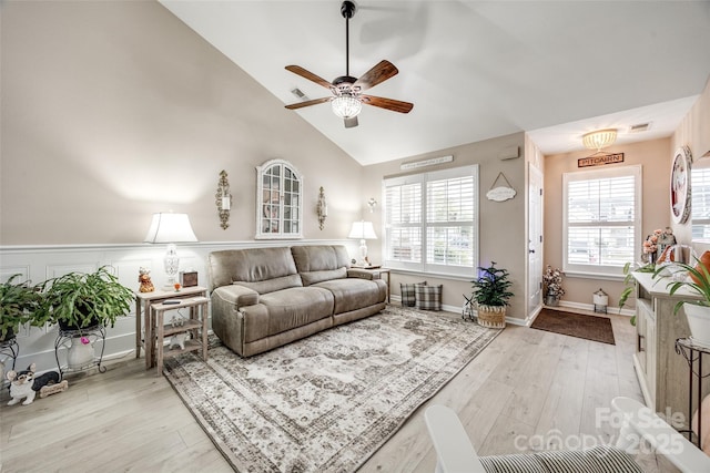 living room featuring light wood-type flooring, vaulted ceiling, and ceiling fan