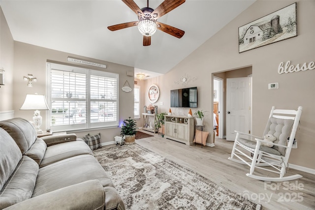 living room featuring light hardwood / wood-style floors, vaulted ceiling, and ceiling fan