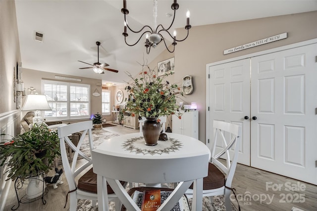 dining area with light wood-type flooring, ceiling fan, and lofted ceiling