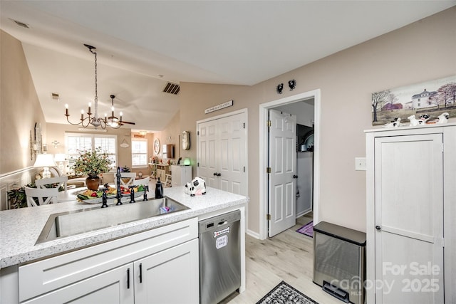 kitchen featuring dishwasher, decorative light fixtures, sink, white cabinets, and a notable chandelier