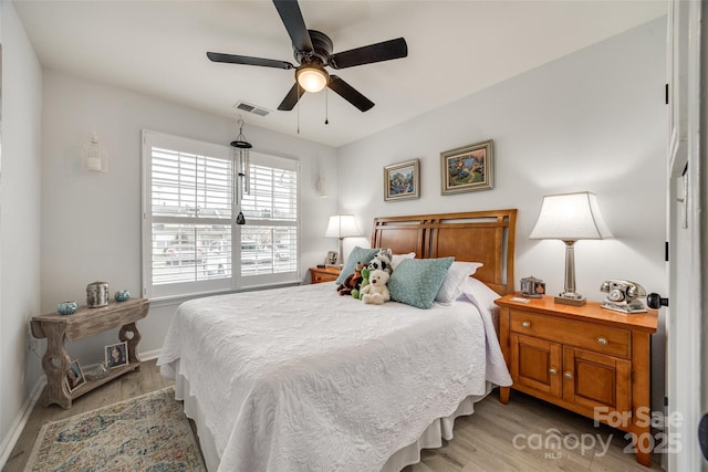 bedroom with ceiling fan and light hardwood / wood-style floors