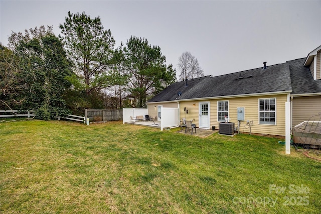 back of property featuring central air condition unit, a lawn, and a patio area