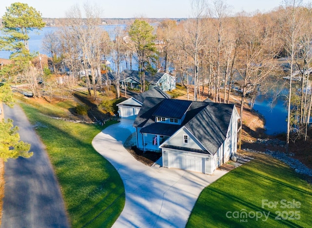 birds eye view of property with a water view