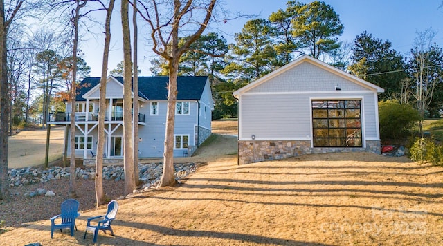 exterior space with a front lawn and a balcony