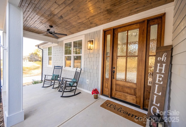 entrance to property with ceiling fan and a porch