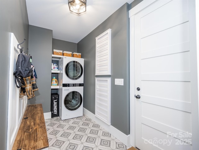 laundry area featuring stacked washer / drying machine