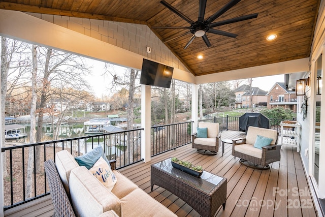 wooden terrace featuring ceiling fan, outdoor lounge area, and grilling area