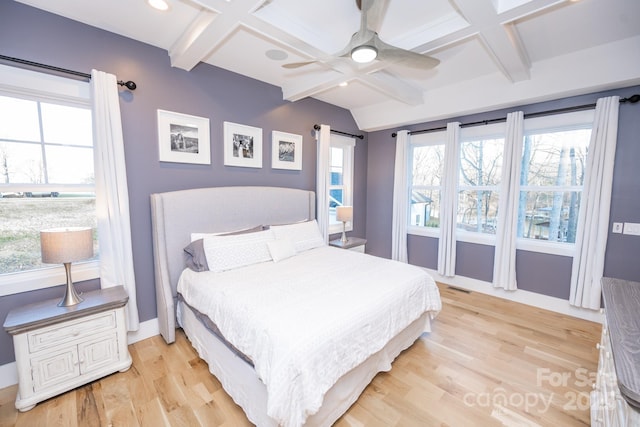 bedroom with ceiling fan, light hardwood / wood-style flooring, beamed ceiling, and coffered ceiling