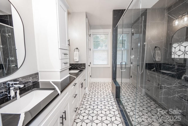 bathroom with vanity and a shower with door