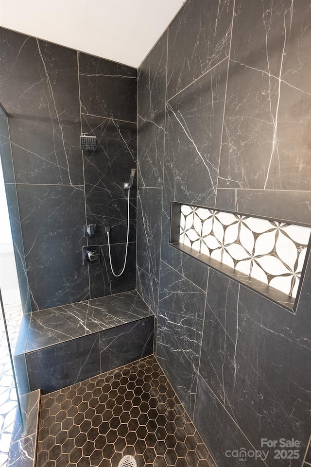 bathroom with tiled shower