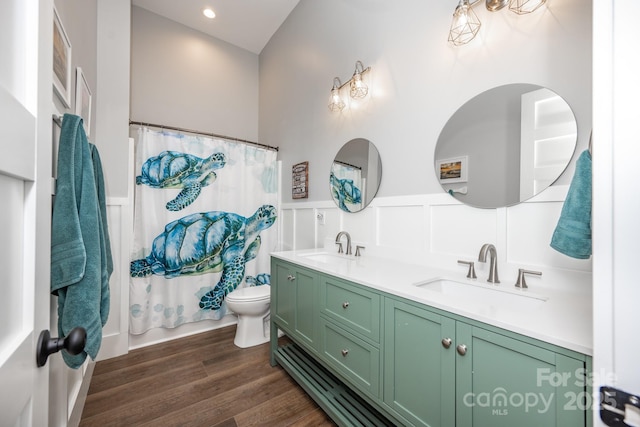 bathroom featuring hardwood / wood-style flooring, toilet, and vanity