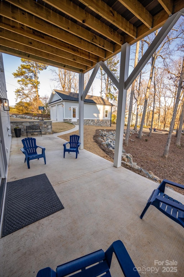 view of patio featuring an outbuilding