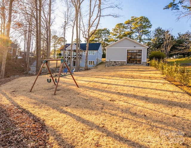 view of yard with a playground and a garage