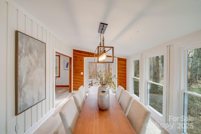 dining area featuring wooden walls